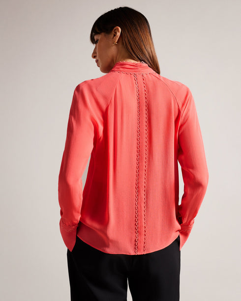 JULINAA-Tops-JULINAA is a lightweight, feminine layer that transitions easily from day to evening. This lightweight blouse pairs wonderfully with wide-leg trousers and heels for a polished office look—or switch it up for jeans and sandals on a sunny weekend getaway. Blouse Neck tie Looped rouleaux trim Long sleeved Button fastening Lightweight fabric Julia is 5'10" / 1.78m and wears Coral in a Ted size 1- Ted Baker Romania